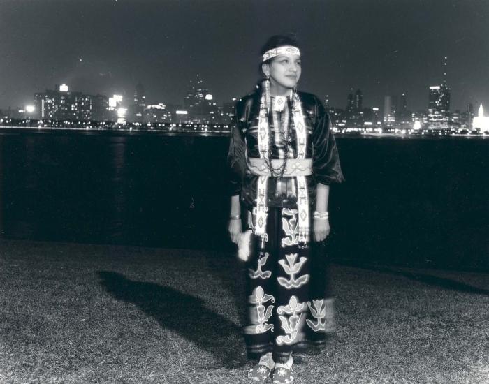 Native community member Linda Benson stands in front of the Chicago skyline. Photograph by Ben Bearskin. Ayer MS Seeing Indian Collection, Newberry Library. 