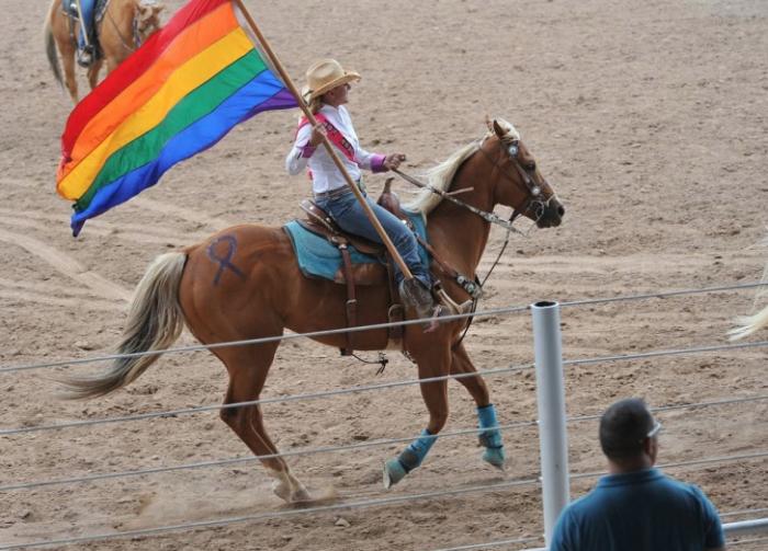 Trotting by with the rainbow flag at a 2011 gay rodeo, photo credit: CowboyFrank.net, International Gay Rodeo Association Trotting by with the rainbow flag at a 2011 gay rodeo, photo credit: CowboyFrank.net, International Gay Rodeo Association