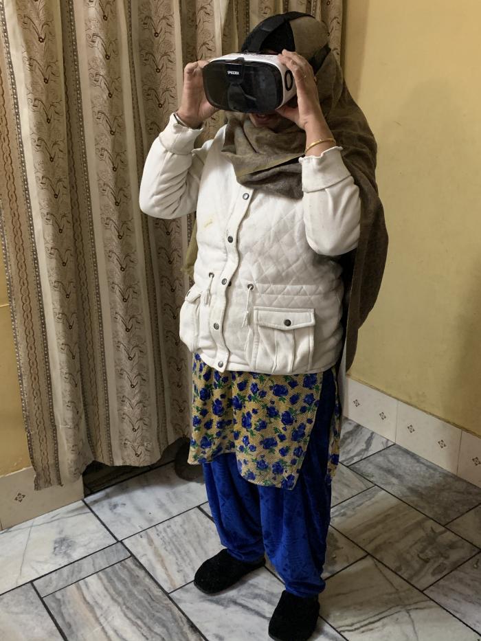 A woman watching a virtual reality film in India