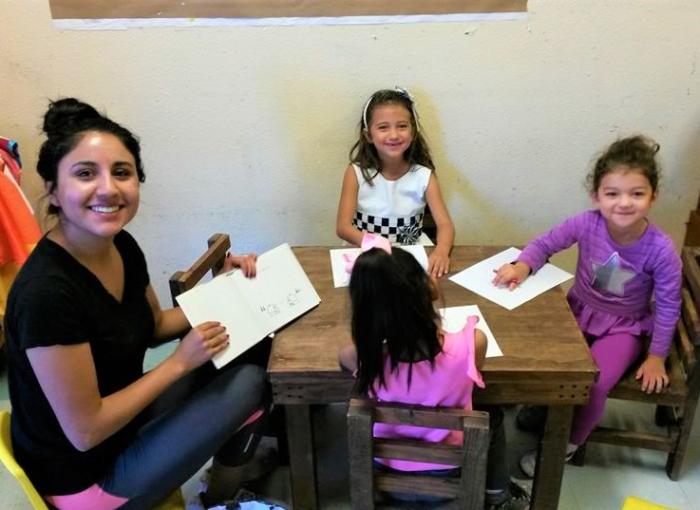 Ilana Gomez leading children through a philosophical exercise at Rayito de Sol Daycare and Learning Center in El Paso. Photo by Amy Reed-Sandoval.