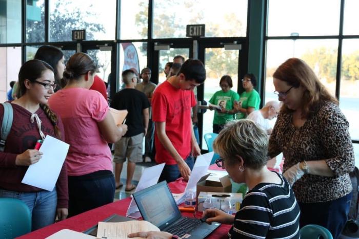 Students participating in a community digitization event of family historical artifacts, Robert Kennedy High School, Delano, California.  Photo by Elisabeth Sundby.