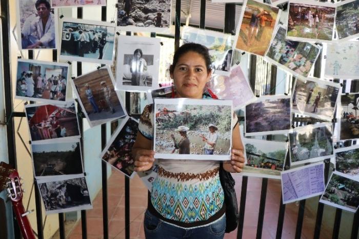 A young woman in Milingo finds a photo of family members working in a refugee camp - photo by Amanda Grzyb A young woman in Milingo finds a photo of family members working in a refugee camp - photo by Amanda Grzyb