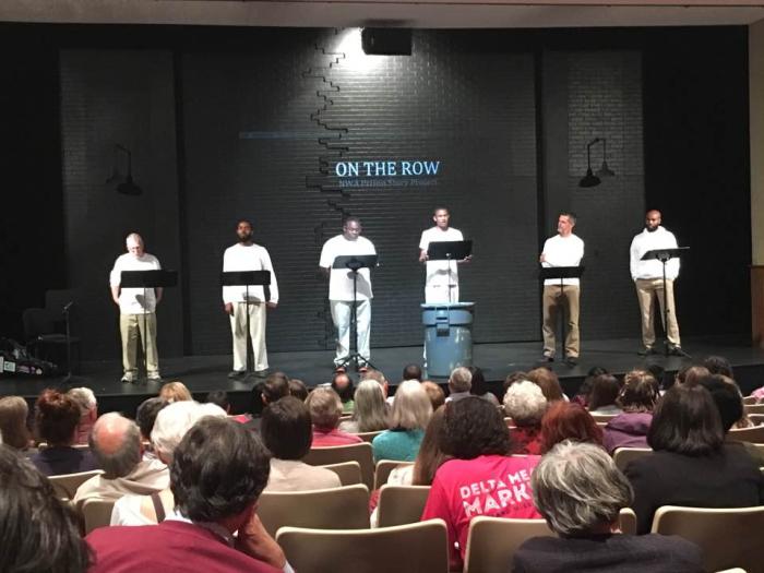 Actors David Jolliffe, Brandon Smith, Kerry Crawford, James Washington, Troy Schremmer, and Austin Ashford performing the staged reading of On The Row at the University of Arkansas, photo by Tiago Santo Actors David Jolliffe, Brandon Smith, Kerry Crawford, James Washington, Troy Schremmer, and Austin Ashford performing the staged reading of On The Row at the University of Arkansas, photo by Tiago Santo