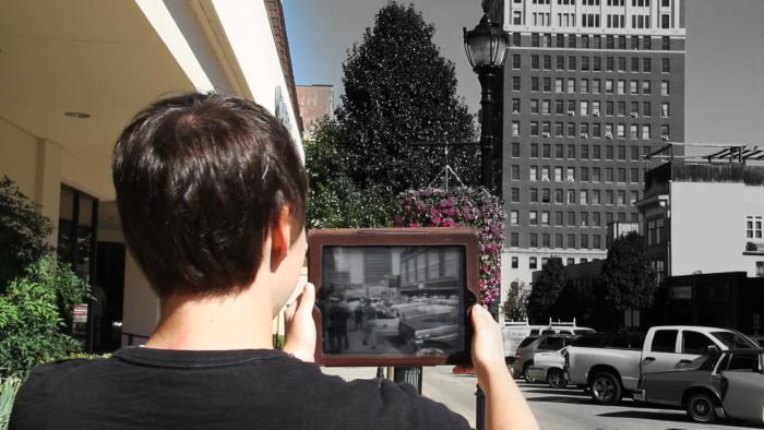 A student using Clio to watch newsreel footage of a 1963 sit-in on the site where it occurred