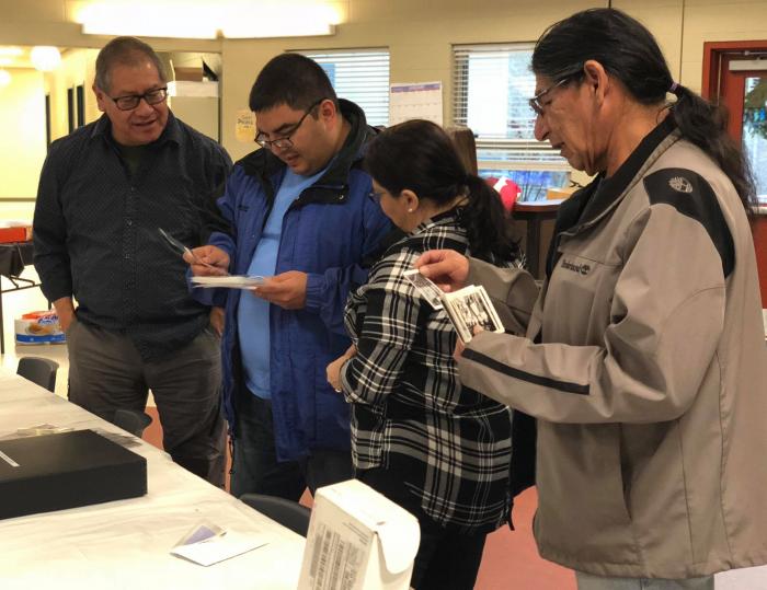 Tuti community members review photos at the kick-off event at the Snowbird Youth Center in January 2018